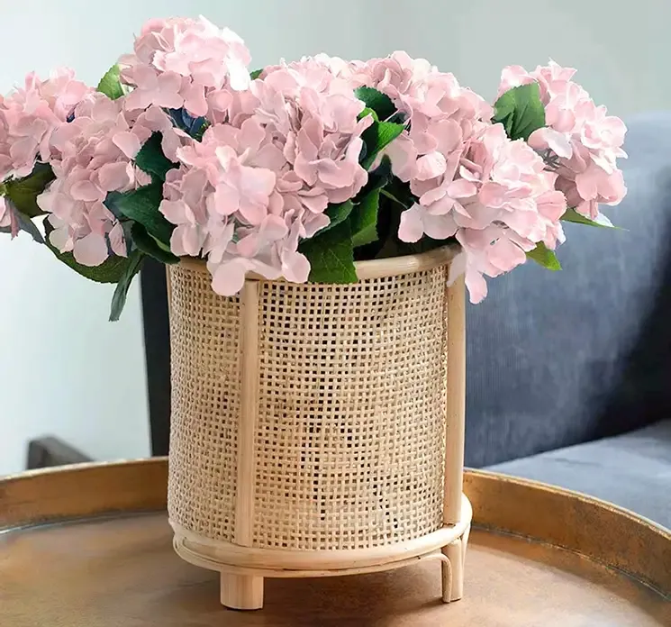 Kunstig hortensia blomst i lyserød af plast vist i miljø på sofabord