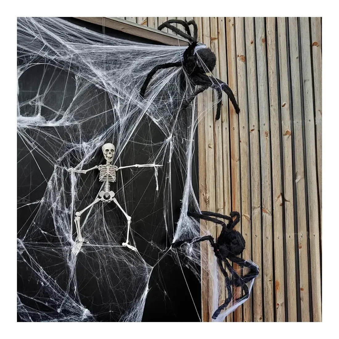 Edderkop kunstig behåret i sort af polyester, halloween pynt vist på dør med skelet