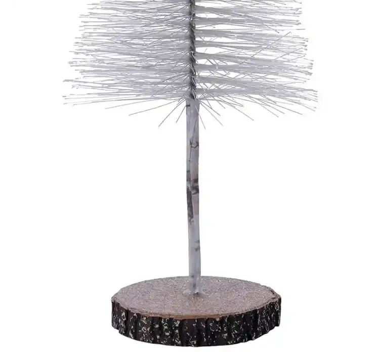 Kunstig børste juletræ af plast i grøn på rund træfod closeup