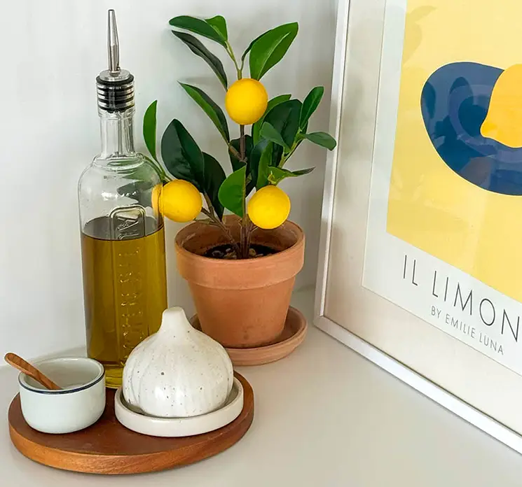 Citron træ med citroner kunstig af plast sat i sort potte med små sten 27cm vist på køkkenbord i krukke