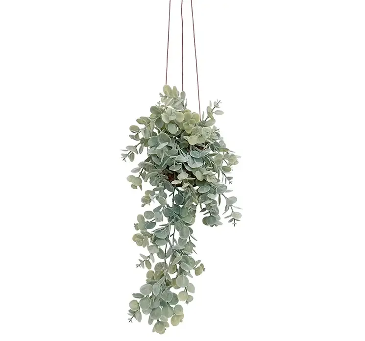 Kunstig eukalyptus hænger af plast i flettet kurv med ophæng